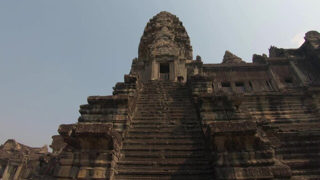 Slow downward pan of a staircase that's part of the ancient temples of Angkor Wat, Cambodia