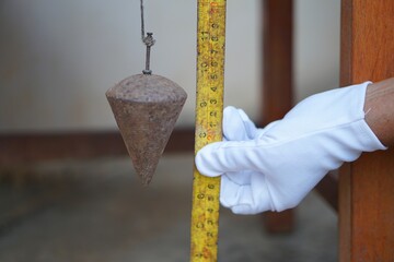 Old rusty metal plumb bob for construction . Thai carpenters or constructors use it for level...