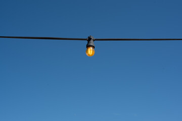 light bulb garland on the blue sky background