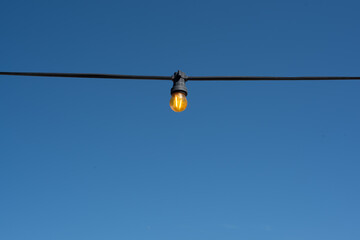 light bulb garland on the blue sky background
