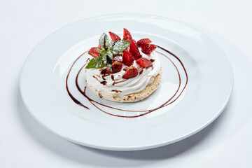 Strawberry pavlova cake on white plate