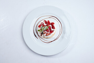 Strawberry pavlova cake on white plate