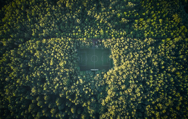 Aerial of soccer pitch in the forest under sunset light © mediaeugene