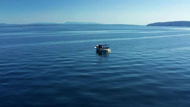 Motorboat Isolated On Scenic Blue Ocean Of Adriatic Sea Near Moscenicka Draga, Croatia. - Aerial Arc Shot