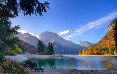 landscape of golden orange and red colors of autumn alps slovenia italy low clouds and first snow...