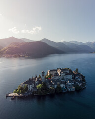 Vertical aerial shot of San Giulio island on lake Orta at sunset.