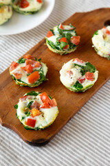 Homemade Egg White Breakfast Cups with Spinach and Tomato, side view.