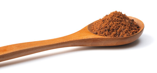 brown sugar in the wooden spoon, isolated on white background