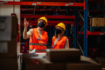 Workers wear protective face mask in warehouse