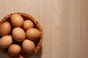 Egg in basket on the table, top view