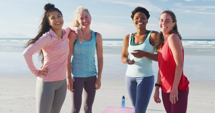 Portrait of happy group of diverse female friends having fun at the beach