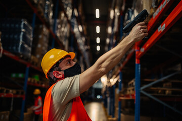 Man using bar-code reader in warehouse