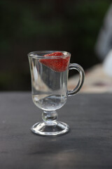 fresh juicy strawberries in a glass of mineral water. Cooling summer drink  