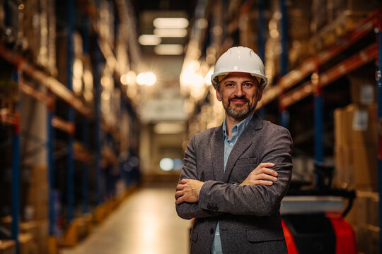 Mid adult manager with crossed arms in a warehouse