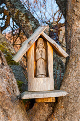 A wooden chapel in an old fruit tree in the village of Rosolin, Polana, Bieszczady Mountains, burnt down after the Second World War.