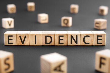 Evidence - word from wooden blocks with letters, Evidence helps to prove concept, random letters around black background