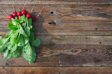 bunch of radishes on a wooden background top view. organic food, raw food