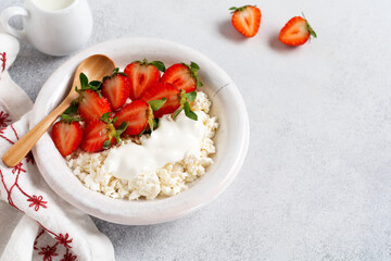 Cottage cheese, curd cheese with strawberries berries in a bowl, ogranic homemade dairy product....