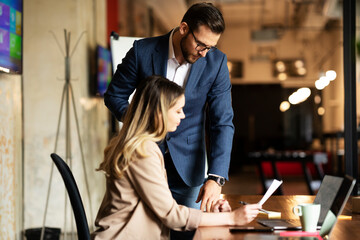 Colleagues in office. Businesswoman and businessman discussing work in office. Two friends working together