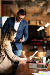 Colleagues in office. Businesswoman and businessman discussing work in office. Two friends working together