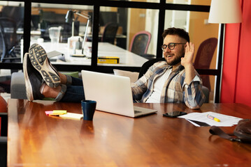 Businessman sitting looking at his laptop. Businessman working in the office on his laptop.