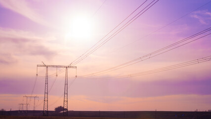 Electric high voltage pole at sunset background