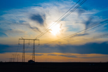 Electric high voltage pole at sunset background