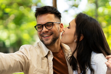 Happy young couple outdoors. Loving couple taking selfie photo