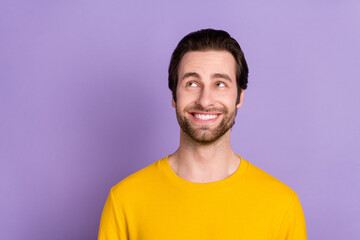 Portrait of attractive cheerful bewildered man thinking copy empty space isolated over pastel violet purple color background