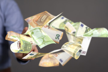 euro bills flying around  in hand