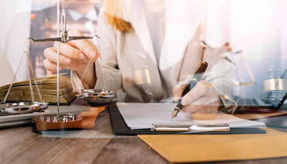 Justice and law concept.Male judge in a courtroom with the gavel, working with, computer and docking keyboard, eyeglasses, on table in morning light