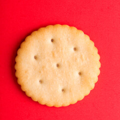 cracker close-up. salty cracker on a red background