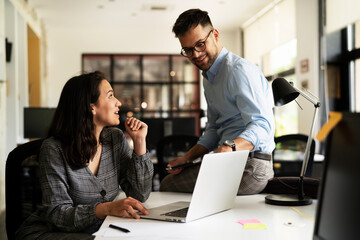 Colleagues in office. Businesswoman and businessman discussing work in office. Two friends working together