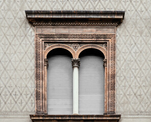 Obraz premium elegant facade with rectangular window with an elaborate terracotta frame with floral motifs