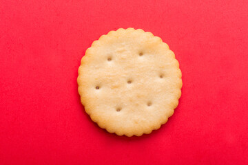 cracker close-up. salty cracker on a red background