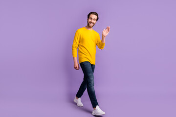 Full length body size view of attractive cheerful man going waving you hi isolated over pastel...