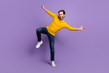 Fototapeta na wymiar Full length body size photo smiling man in casual outfit dancing overjoyed laughing isolated pastel purple color background