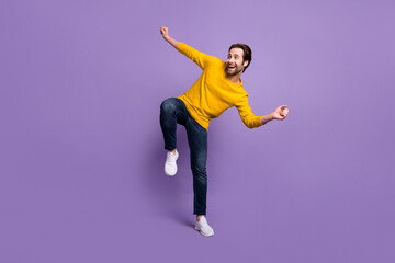 Fototapeta na wymiar Full length body size view of attractive cheerful man dancing having fun isolated over pastel violet purple color background