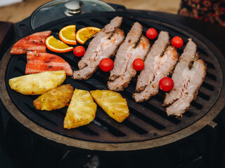 BBQ grilled brisket meat with pineapple and watermelon on metal grid