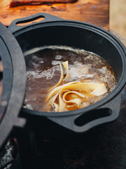 Cooking bowling of pasta tagliatelle fettuccini in bowler hat