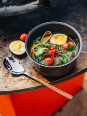 Ramen soup with egg meat brisket noodles on meatl grill