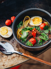 Ramen soup with egg meat brisket noodles on meatl grill