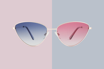 sunglasses golden metallic frame and blue and red polarized lenses isolated on pink background