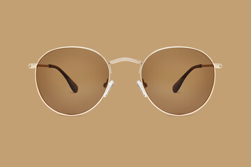 sunglasses golden metallic frame and polarized lenses isolated on brown background