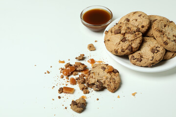 Tasty cookies with caramel on white background