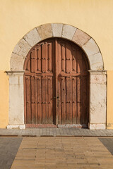 Old wooden gate with stone arch