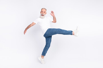 Full length body size view of nice funny cheerful man walking making step having fun isolated over light grey color background