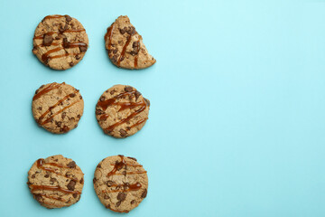 Cookies with caramel on blue background, space for text