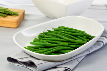 Steamed green beans in white bowl on table - Powered by Adobe