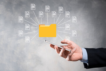 Document Management System DMS .Businessman hold folder and document icon.Software for archiving, searching and managing corporate files and information.Internet Technology Concept.Digital security.